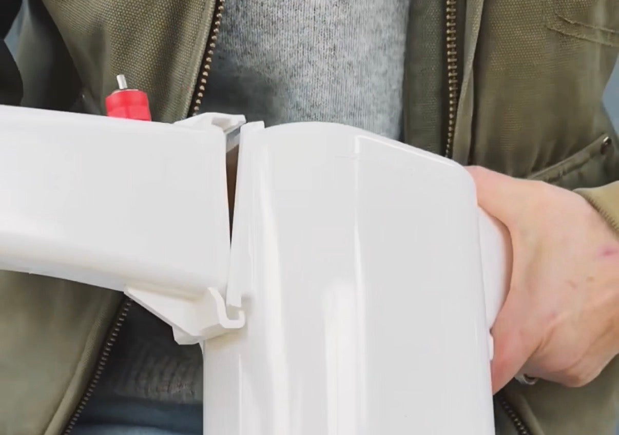 Person snapping the arm onto the Chicken Fountain body during assembly.